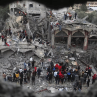 Palestinians search for survivors of the Israeli bombing in Rafah, Gaza on 22 November 2023 (AP)